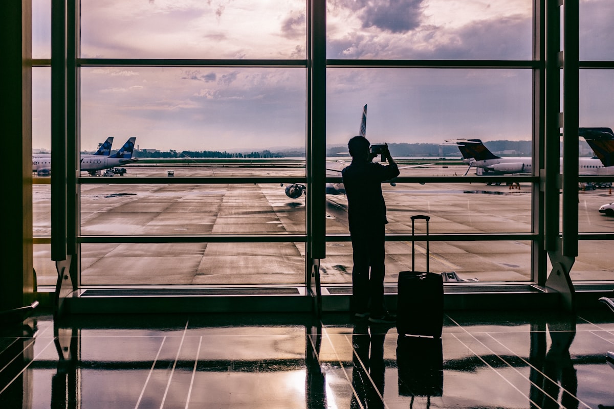 Traveler at the airport staying connected on a smartphone