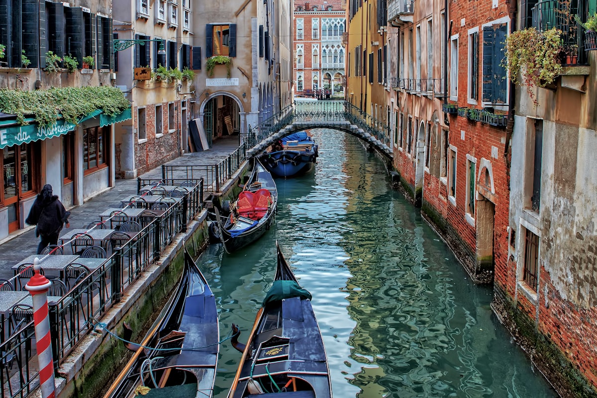 Venice canal with gondolas between historic buildings